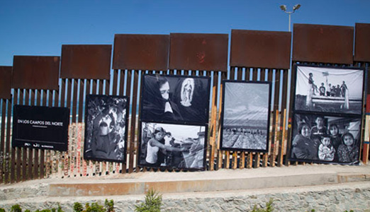 “In the Fields of the North” photos on the border wall