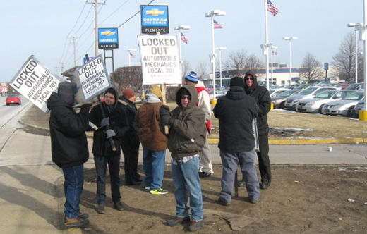 Striking auto mechanics locked out, putting up a fight