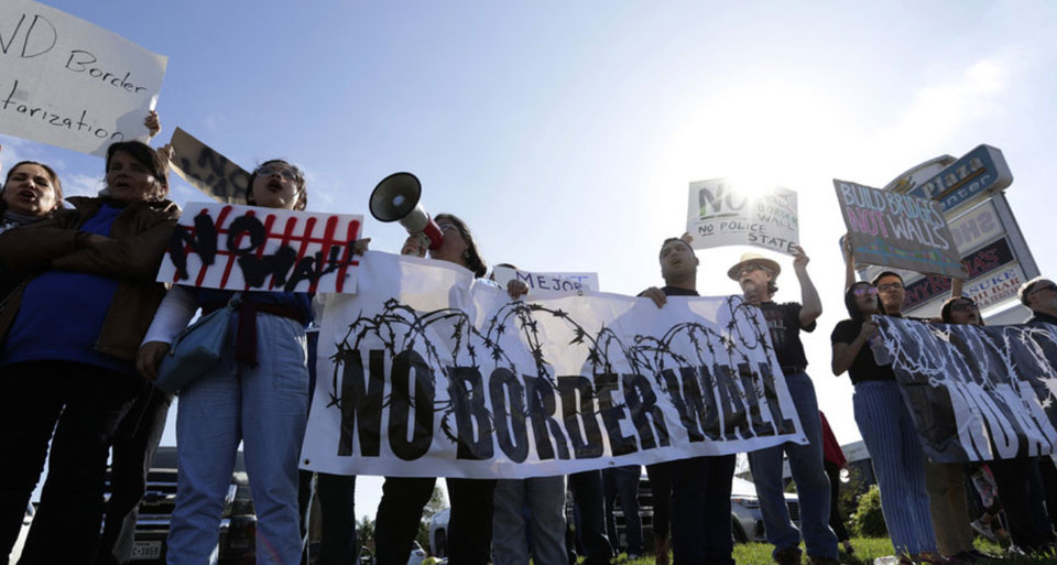 Thousands protest at the border as Trump tours Texas wall site