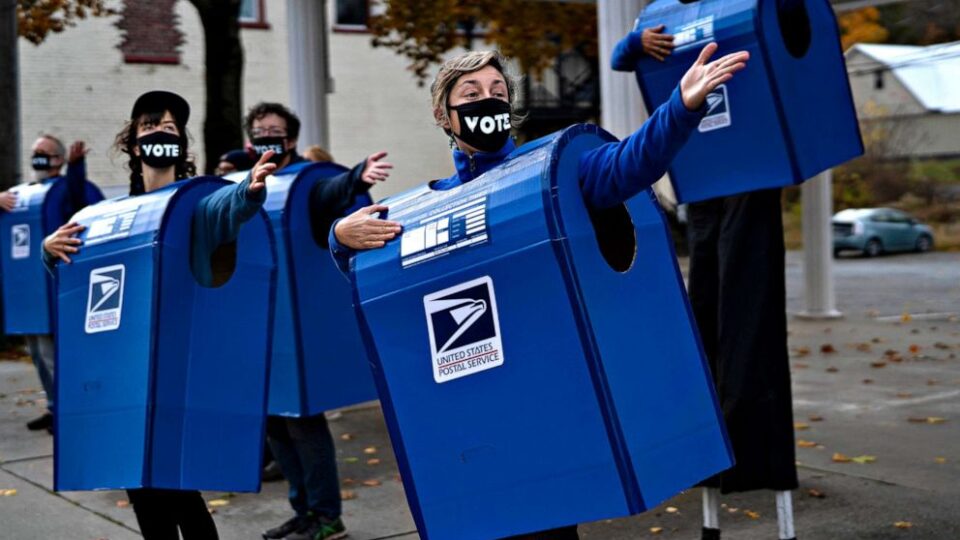 Put postal workers on the list of election heroes