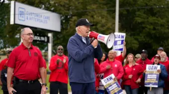 President Joe Biden joins striking United Auto Workers on the picket line, in Van Buren Township, Mich. United Auto Workers President Shawn Fain stands at left.