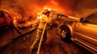 Firefighters battle devastating Los Angeles wildfires as winds calm somewhat