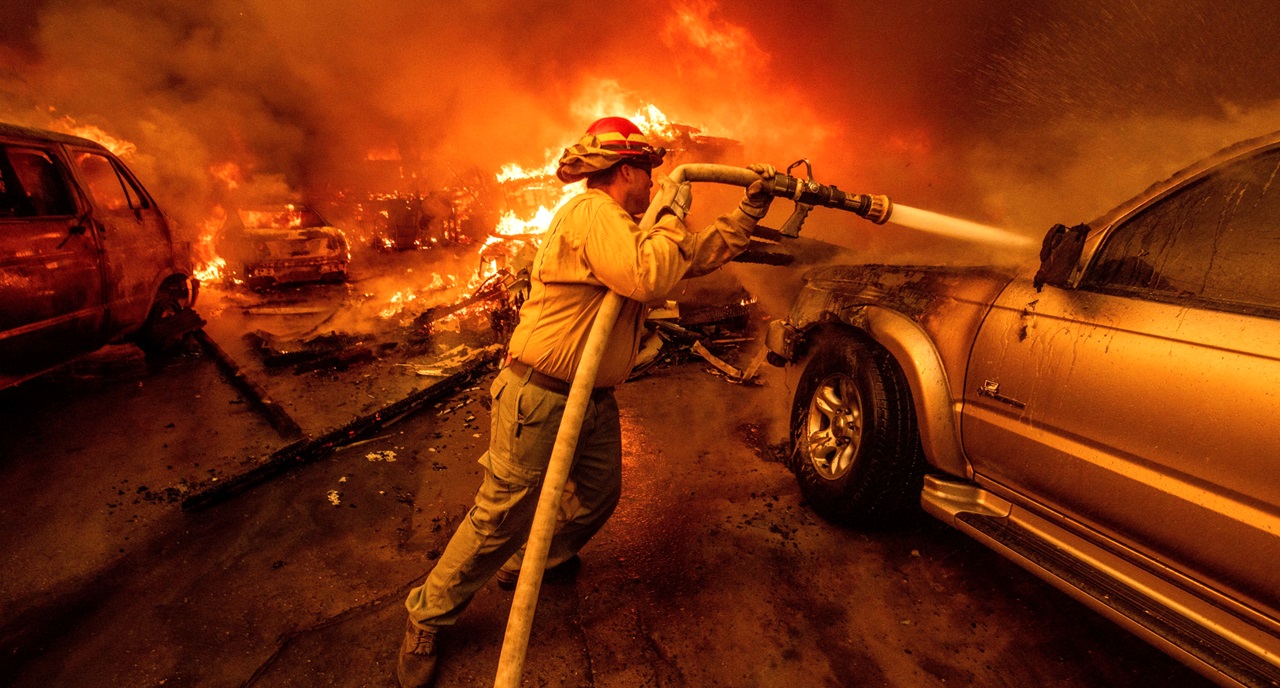 Firefighters battle devastating Los Angeles wildfires as winds calm somewhat