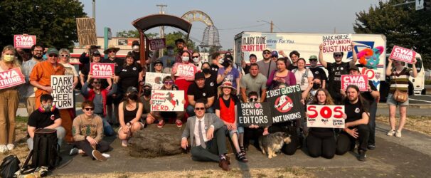 Group photo of rally attendees with their protest signs