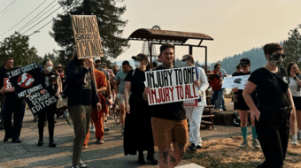 Supporters of DHWU showing off their union T-shirts and signs reading: I bust ghosts, not unions! DHWU loves Senior Editors! Villains should be fictional! Injury to one, Injury to all!
